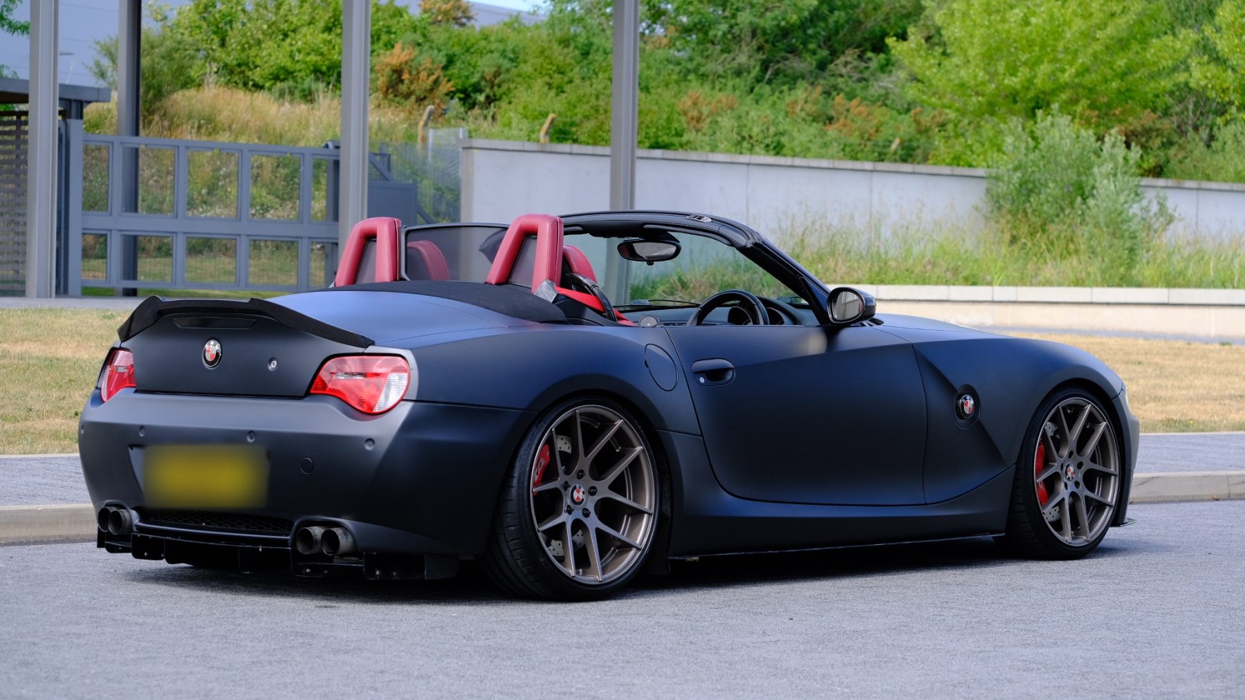 Matt black Z4 roadster with red seats and bronze wheels, parked at ZedNation