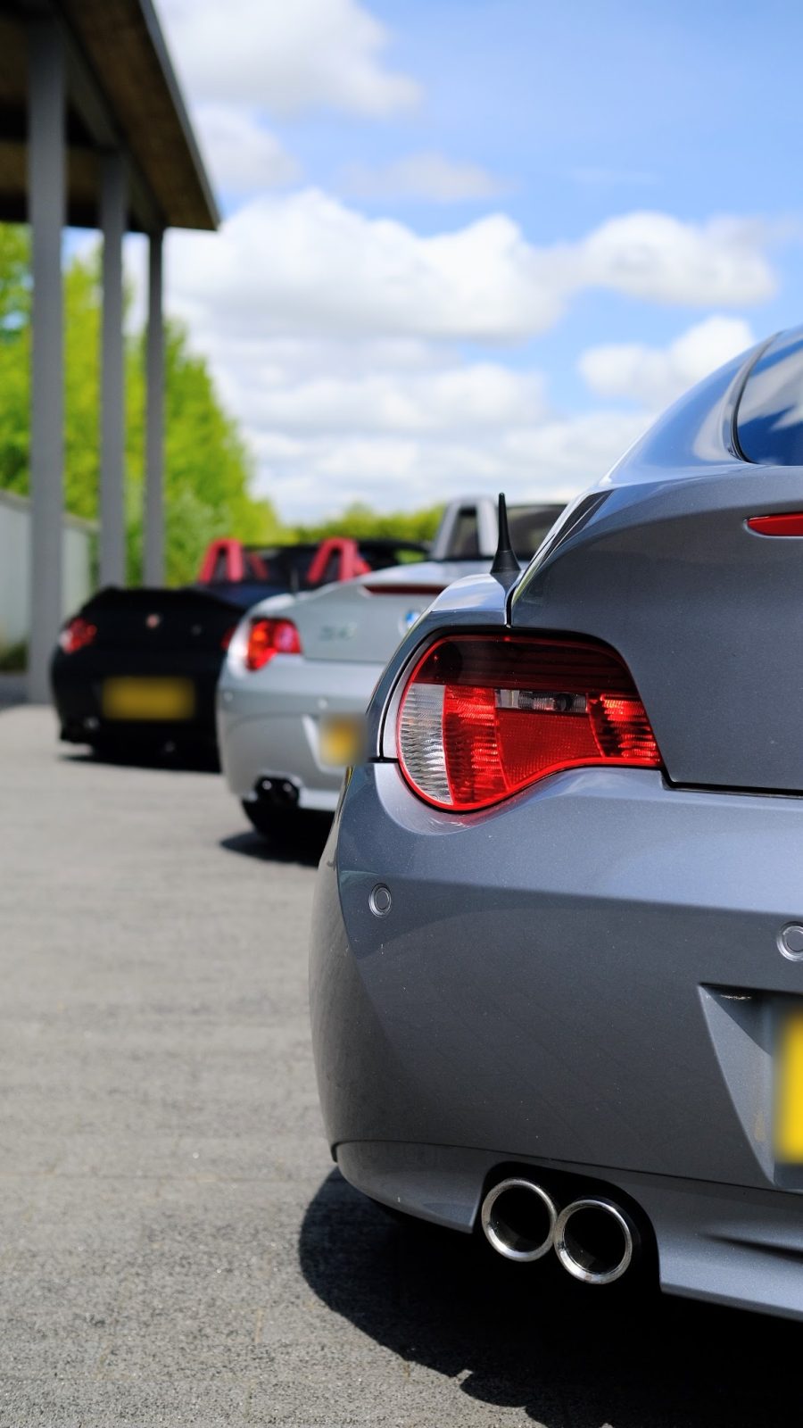 Rear of a grey Z4 Coupe with a row of Z4s parked behind it